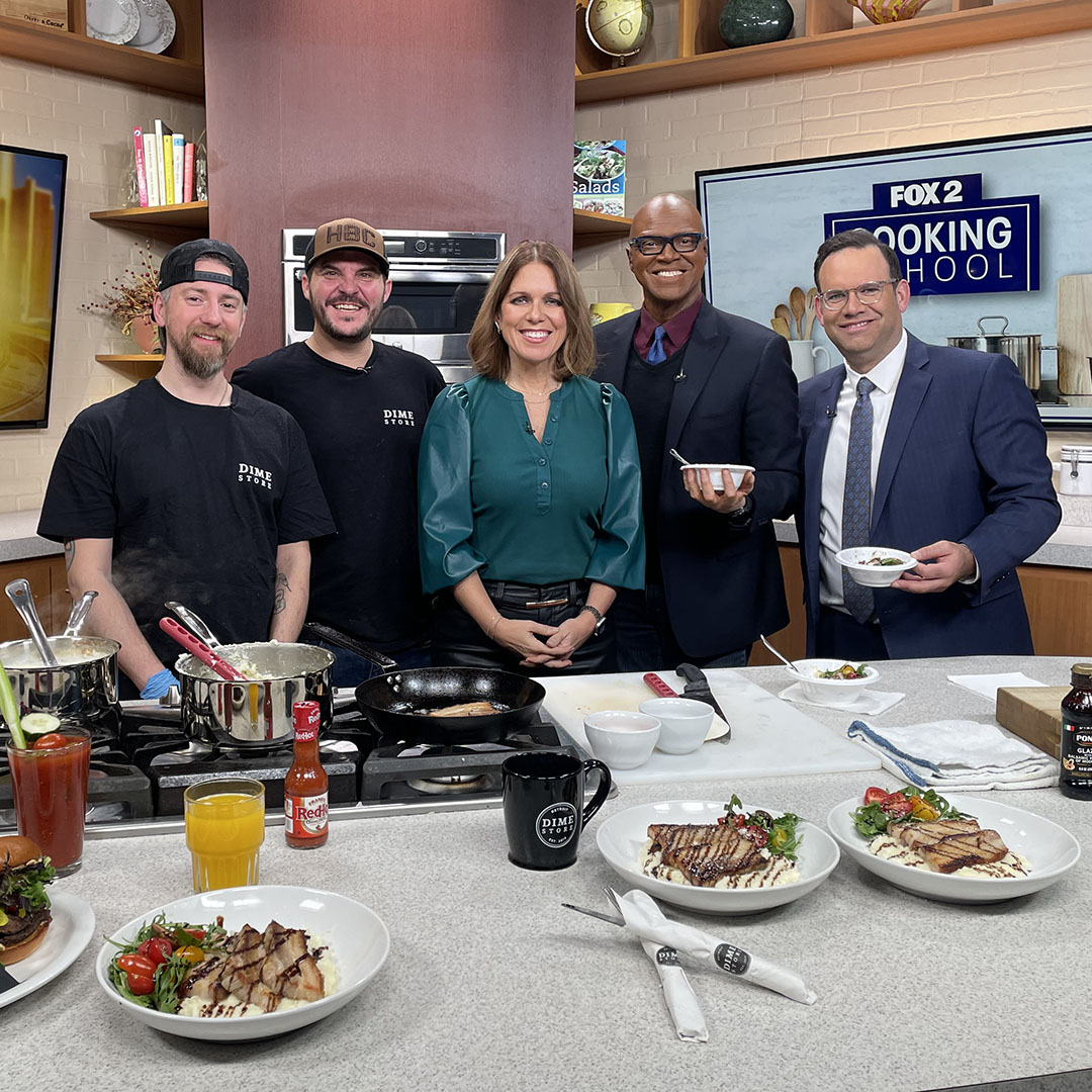 Mitchell Freem and Chef Evan cooking Pork Belly & Grits on Fox 2 Detroit’s Cooking School segment, showcasing Dime Store Rochester Hills.